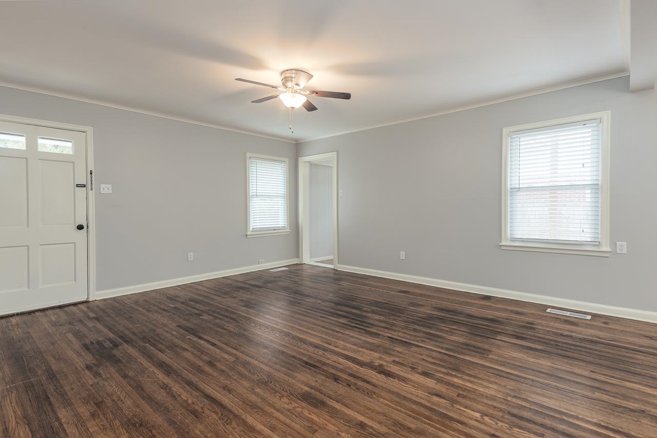 1368 South Perkins Road Memphis, TN 38117 - Photo 6 of 21 a view of an empty room with wooden floor and a window