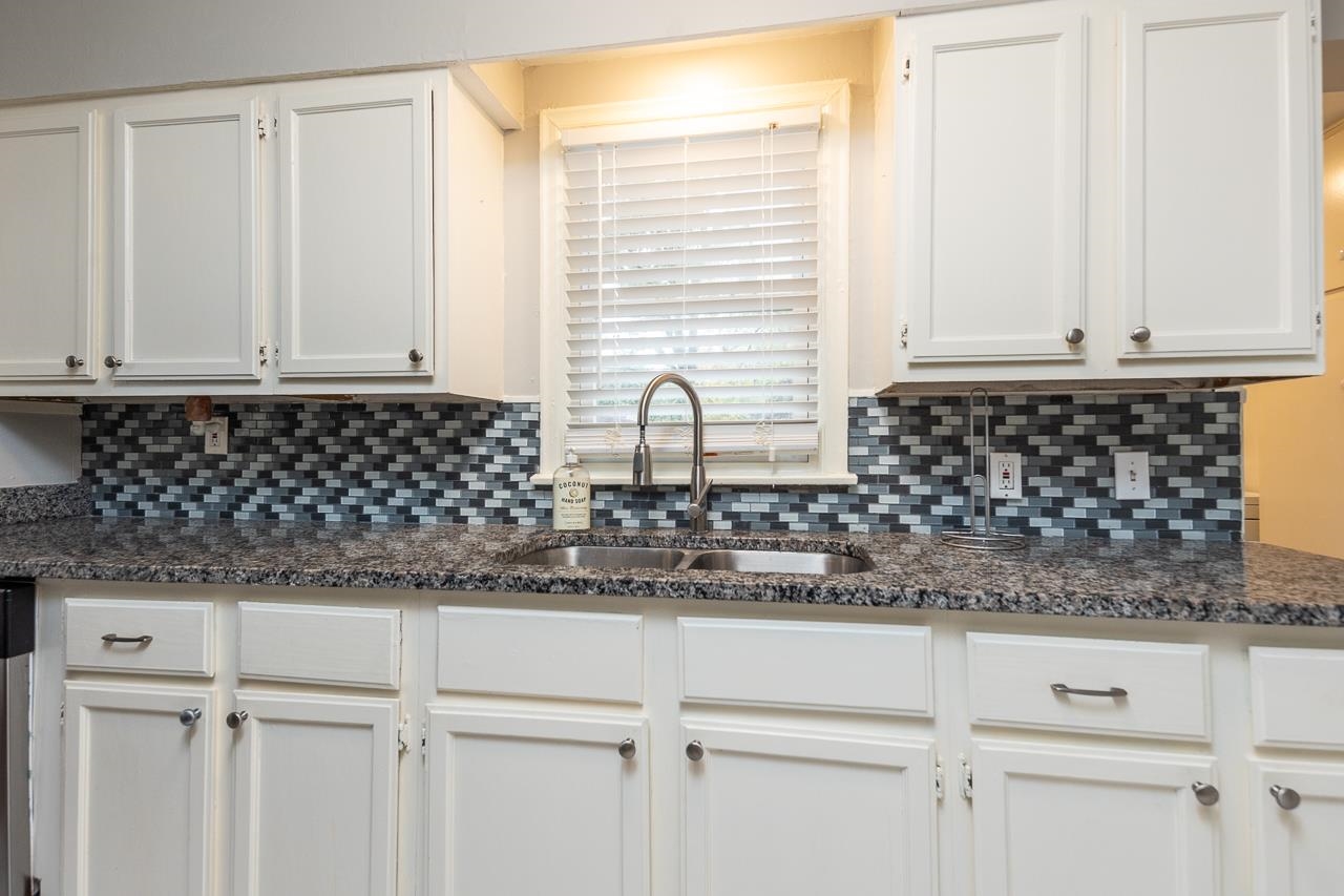 1368 South Perkins Road Memphis, TN 38117 - Photo 10 of 21 a bathroom with a granite countertop white cabinets and a sink