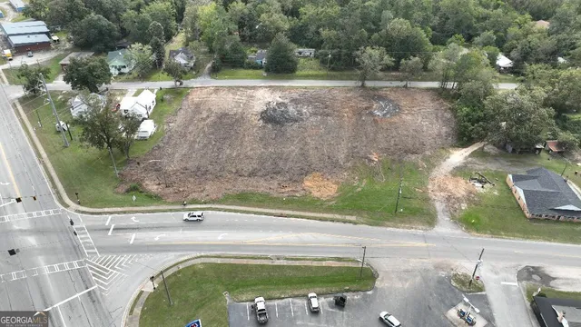 an aerial view of a house with a yard