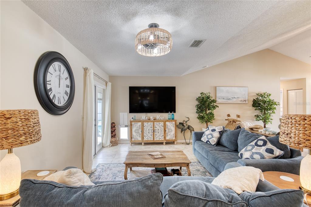 23 Fallon Lane Palm Coast, FL 32137 - Photo 13 of 77 a living room with furniture a flat screen tv and a wall painting