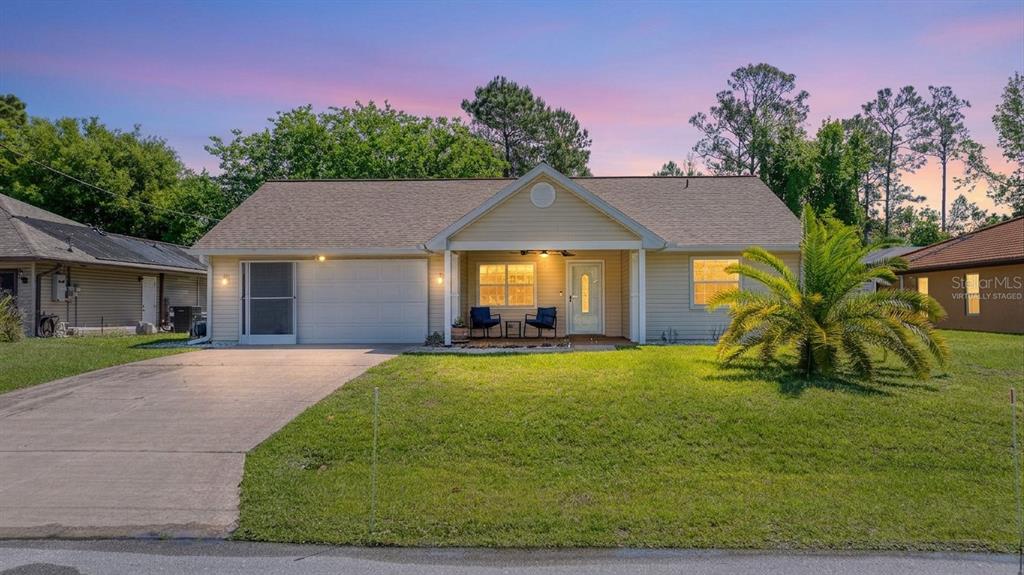 23 Fallon Lane Palm Coast, FL 32137 - Photo 2 of 77 a view of a house with a yard
