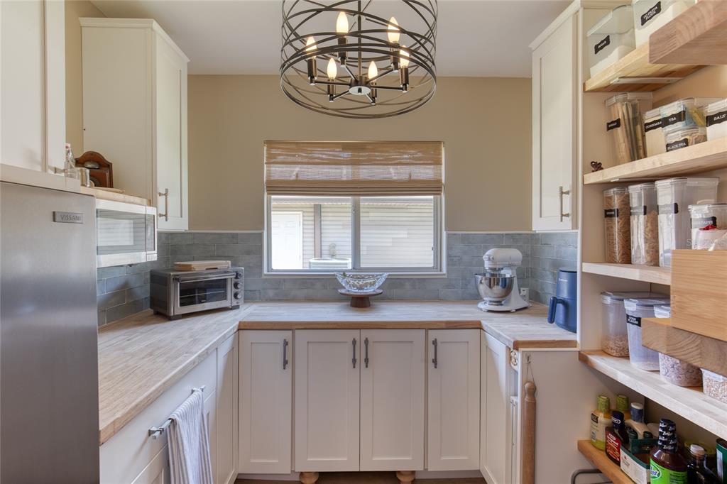 23 Fallon Lane Palm Coast, FL 32137 - Photo 21 of 77 a kitchen with granite countertop a sink a stove and cabinets
