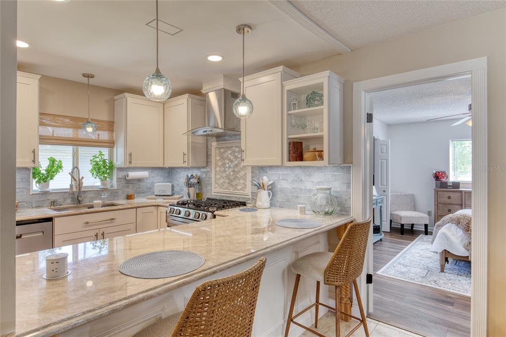 23 Fallon Lane Palm Coast, FL 32137 - Photo 24 of 77 a kitchen with granite countertop a sink dining table and chairs