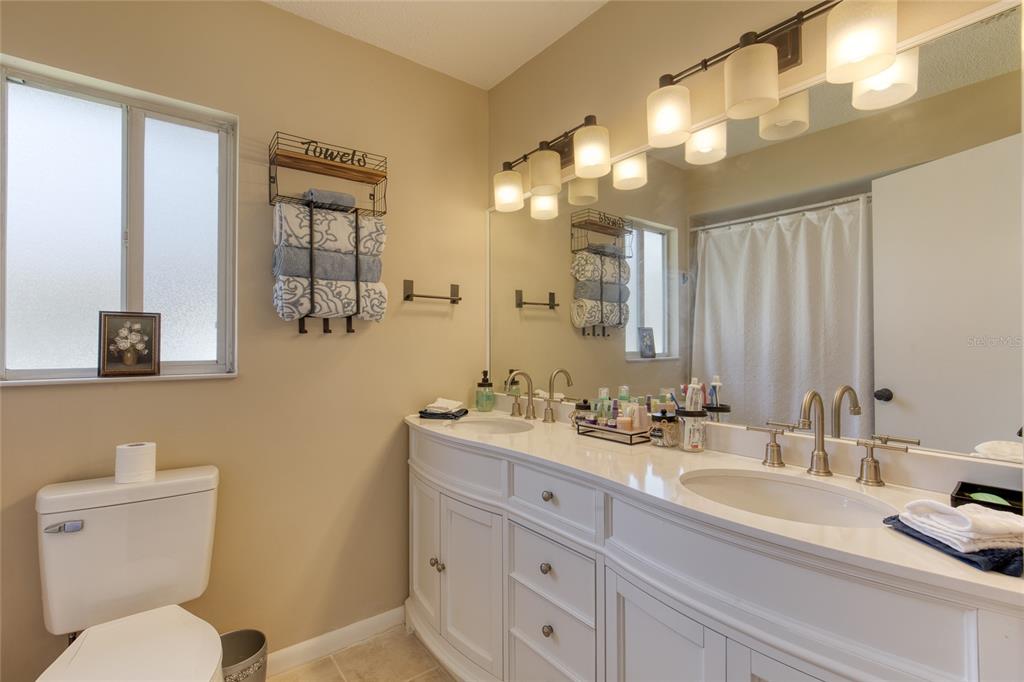 23 Fallon Lane Palm Coast, FL 32137 - Photo 29 of 77 a bathroom with a toilet a sink and mirror