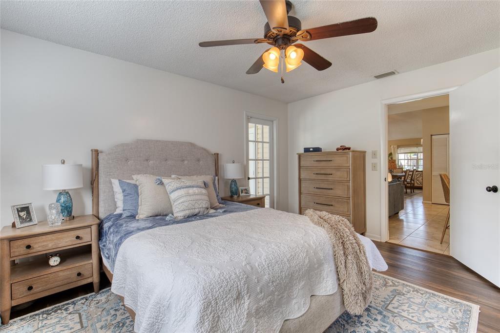 23 Fallon Lane Palm Coast, FL 32137 - Photo 32 of 77 a bedroom with a bed and a chandelier