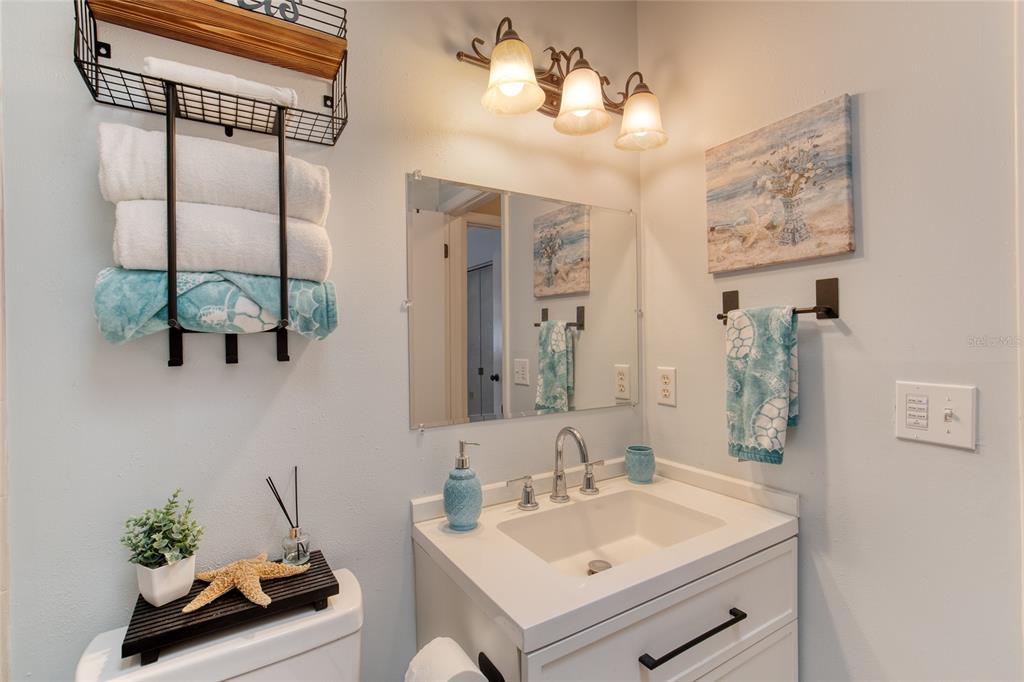 23 Fallon Lane Palm Coast, FL 32137 - Photo 37 of 77 a bathroom with a sink mirror and vanity