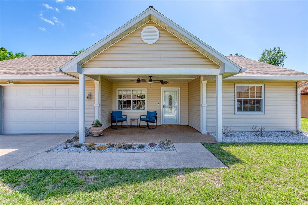 23 Fallon Lane Palm Coast, FL 32137 - Photo 5 of 77 a front view of house with yard and outdoor seating