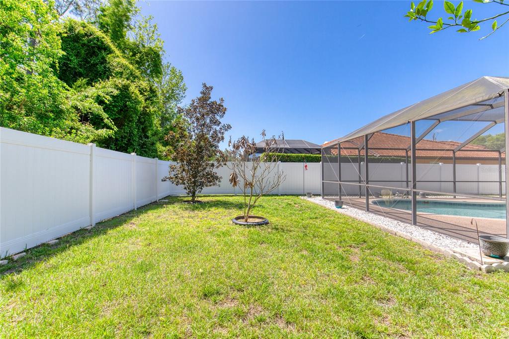 23 Fallon Lane Palm Coast, FL 32137 - Photo 56 of 77 a swimming pool with some trees in the background