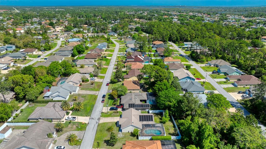 23 Fallon Lane Palm Coast, FL 32137 - Photo 76 of 77 an aerial view of residential houses with outdoor space and trees