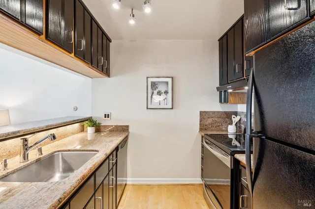 a bathroom with a granite countertop sink a toilet and a bathtub