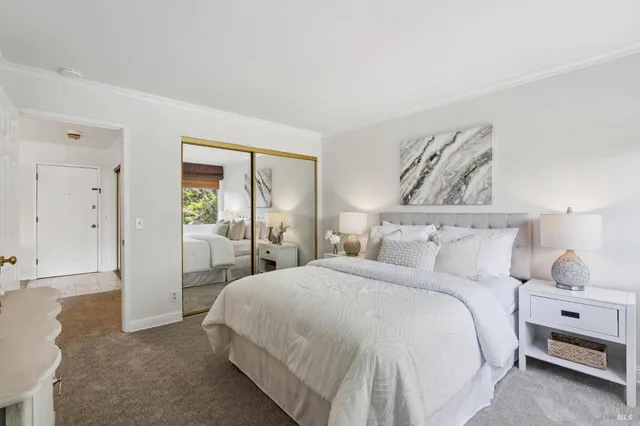 a view of a large building with a plants and a table and chairs