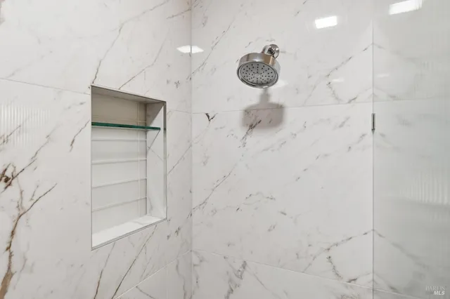 a view of a garden with potted plants and large trees