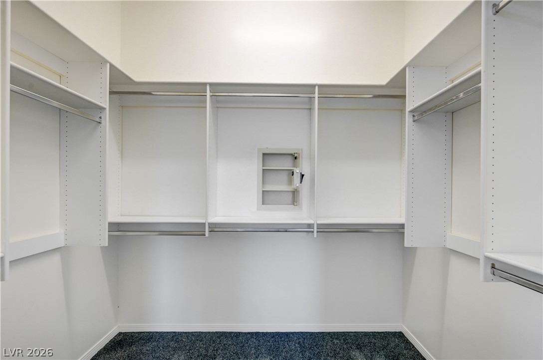 360 East Desert Inn Road, Unit 402 Las Vegas, NV 89109 - Photo 24 of 40 An organized walk-in closet with ample shelving and hanging space.