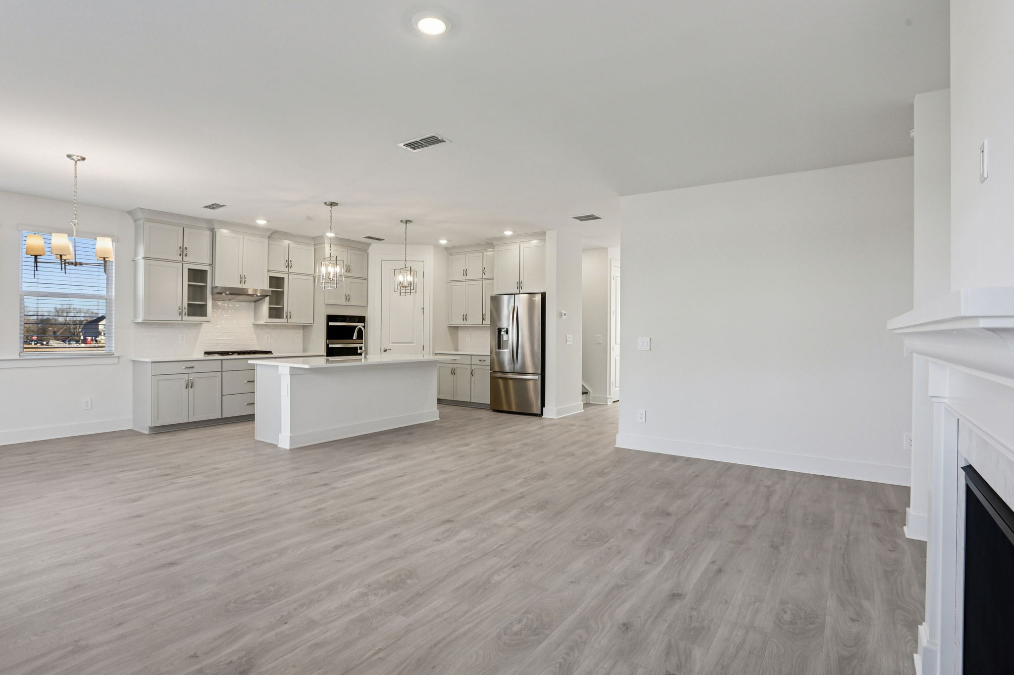 2116 Riley Pk Drive Franklin, TN 37064 - Photo 7 of 47 a view of a kitchen with a sink a refrigerator and a stove top oven
