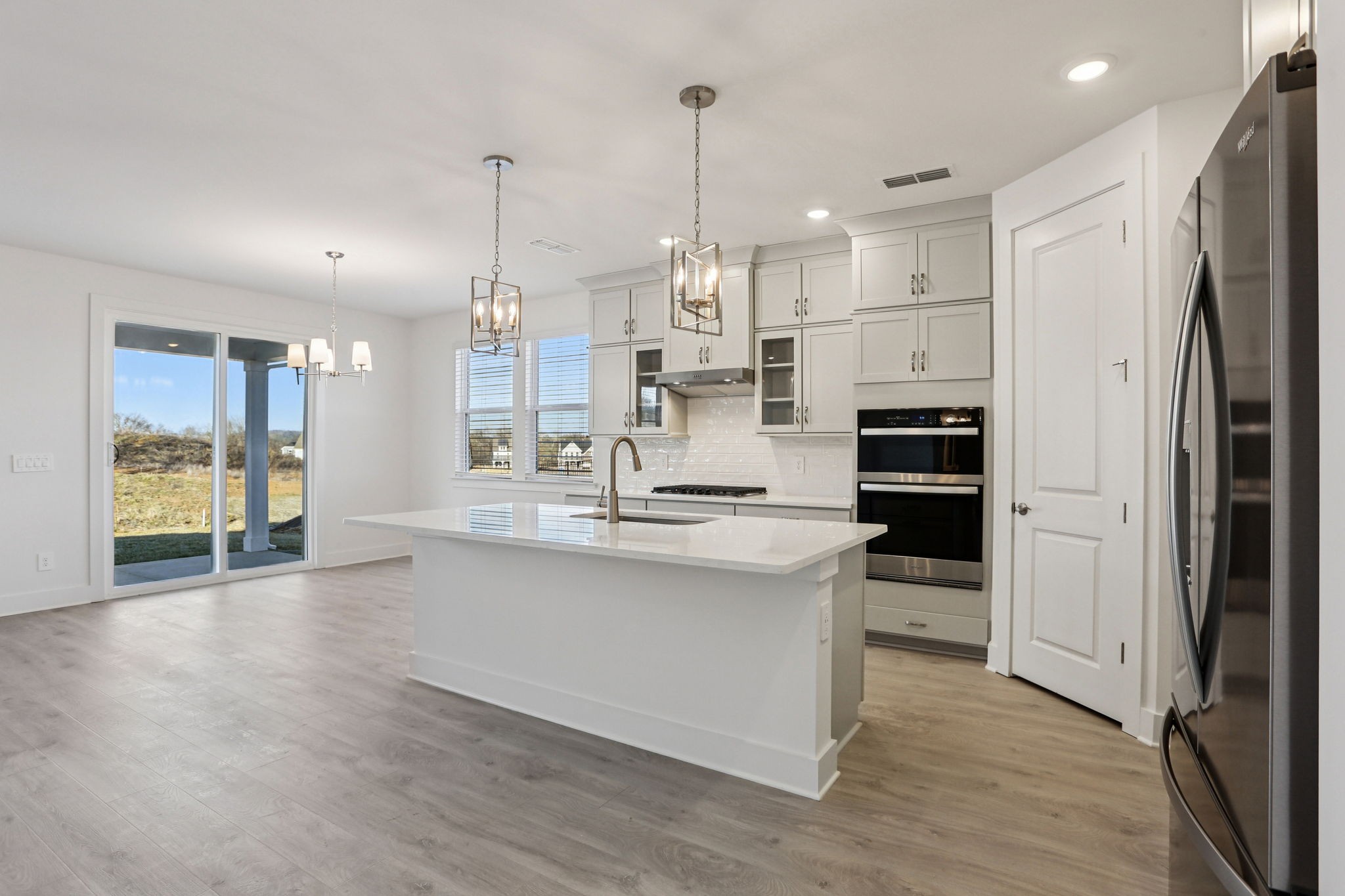 2116 Riley Pk Drive Franklin, TN 37064 - Photo 8 of 47 a kitchen with stainless steel appliances kitchen island granite countertop a refrigerator a oven a sink and white cabinets with wooden floor