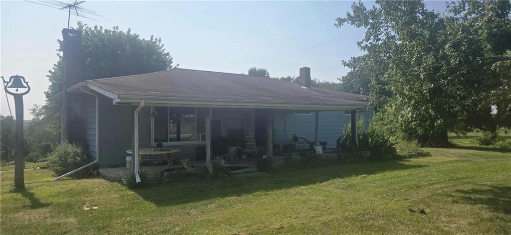a view of a house with backyard and sitting area