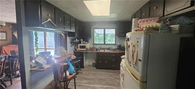 a kitchen with refrigerator and window