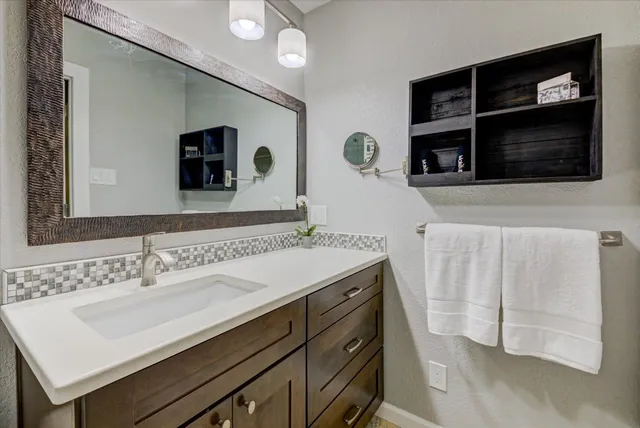 a bathroom with a sink toilet and shower
