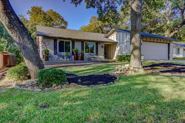 a front view of house with yard outdoor seating and green space