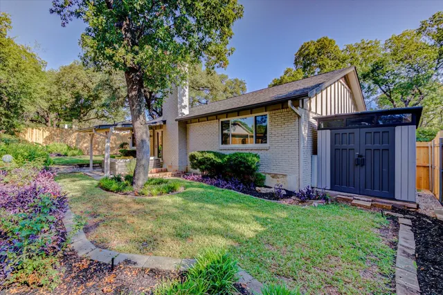 a front view of a house with garden