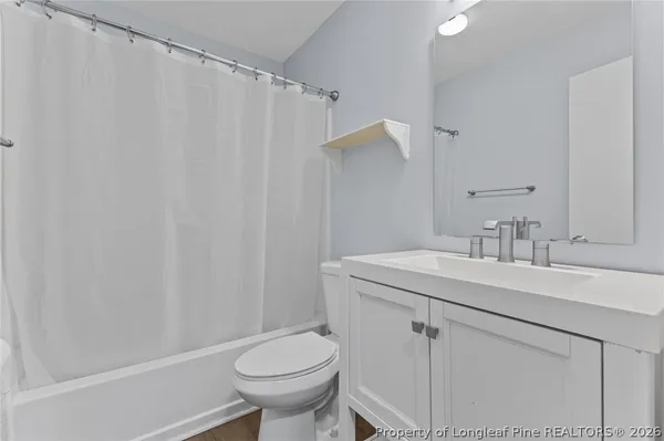 a bathroom with a sink toilet and vanity