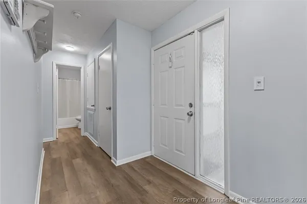 a view of a hallway with wooden floor