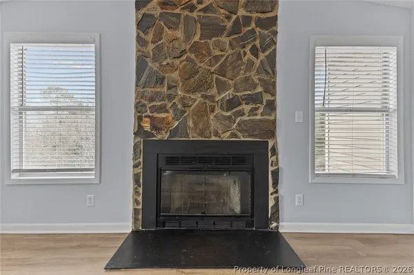 a living room with a fireplace and a window