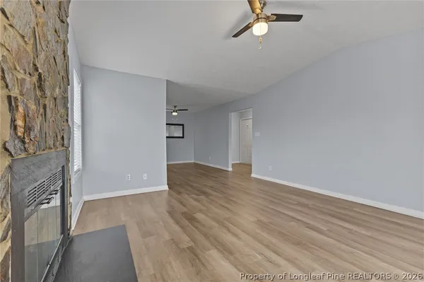 a view of a livingroom with wooden floor and a ceiling fan