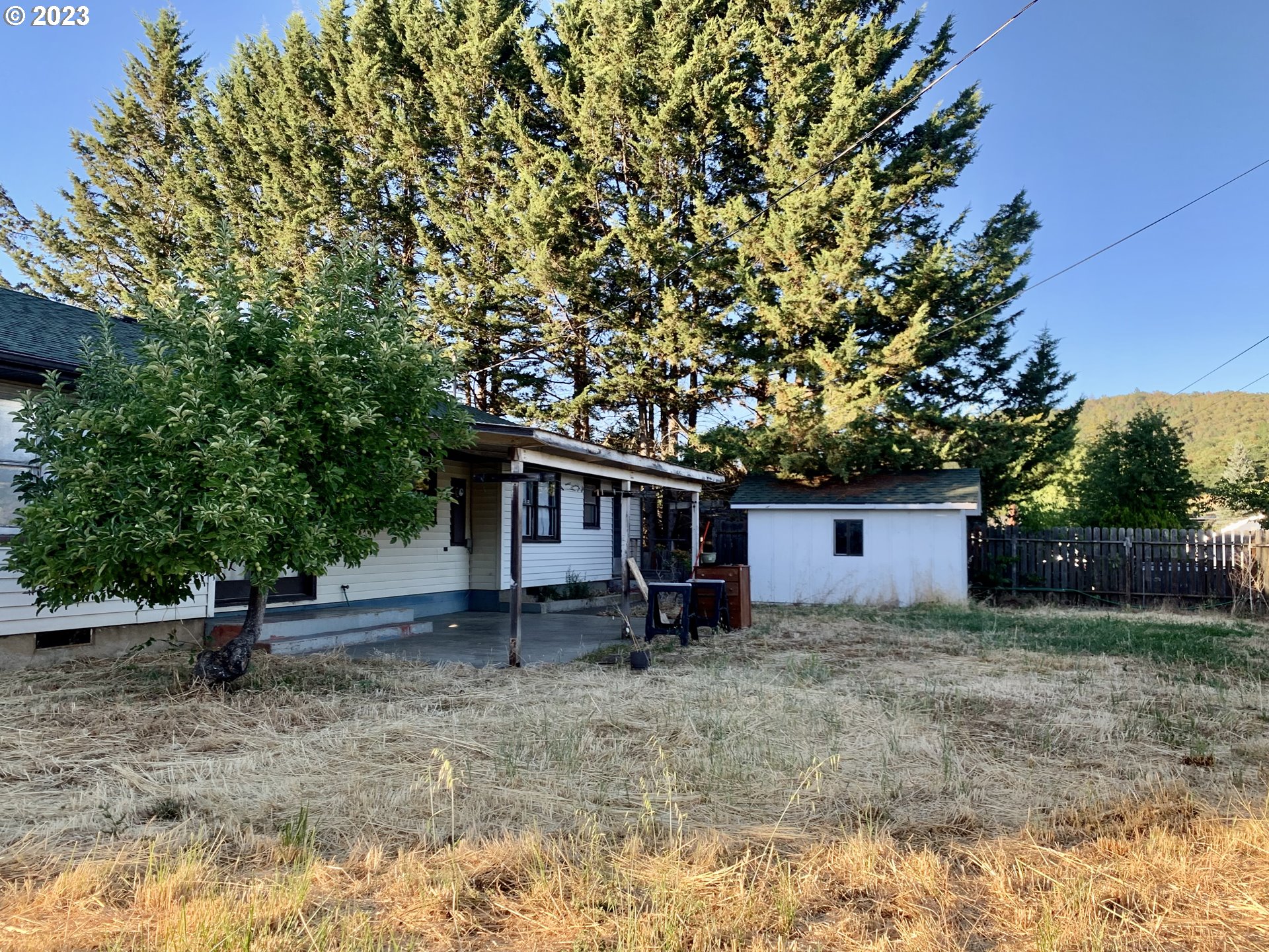 689 East 3rd Avenue Riddle, OR 97469 - Photo 14 of 17 a view of a house with a backyard