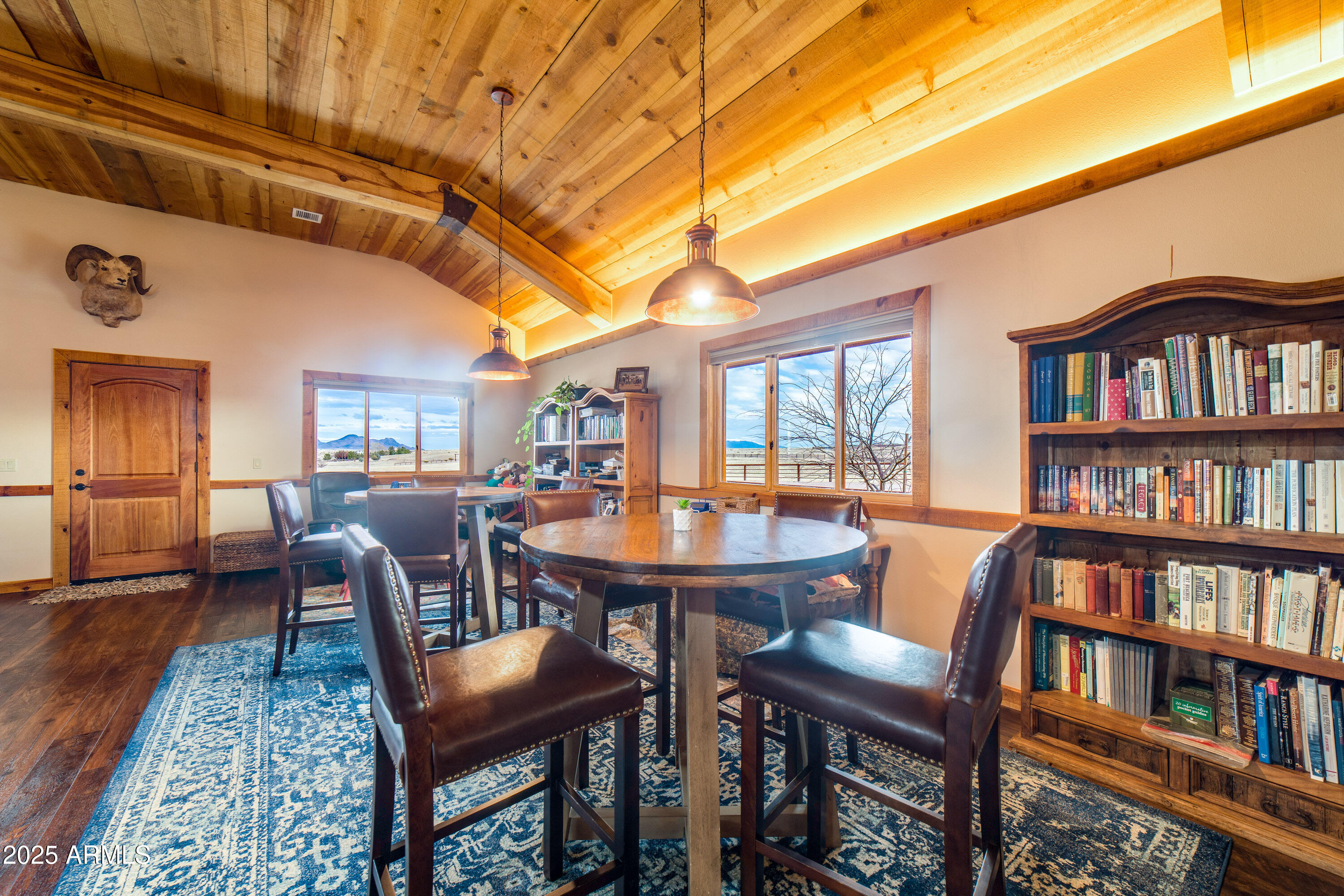 68 Curly Horse Ranch Road Sonoita, AZ 85637 - Photo 11 of 39 a dining room with furniture and a book shelf