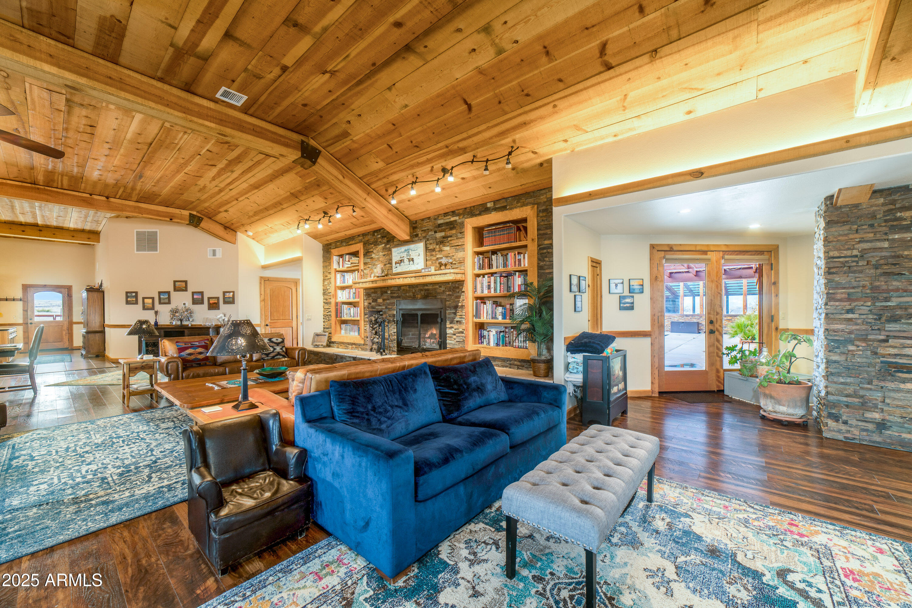 68 Curly Horse Ranch Road Sonoita, AZ 85637 - Photo 12 of 39 a living room with furniture and a fireplace