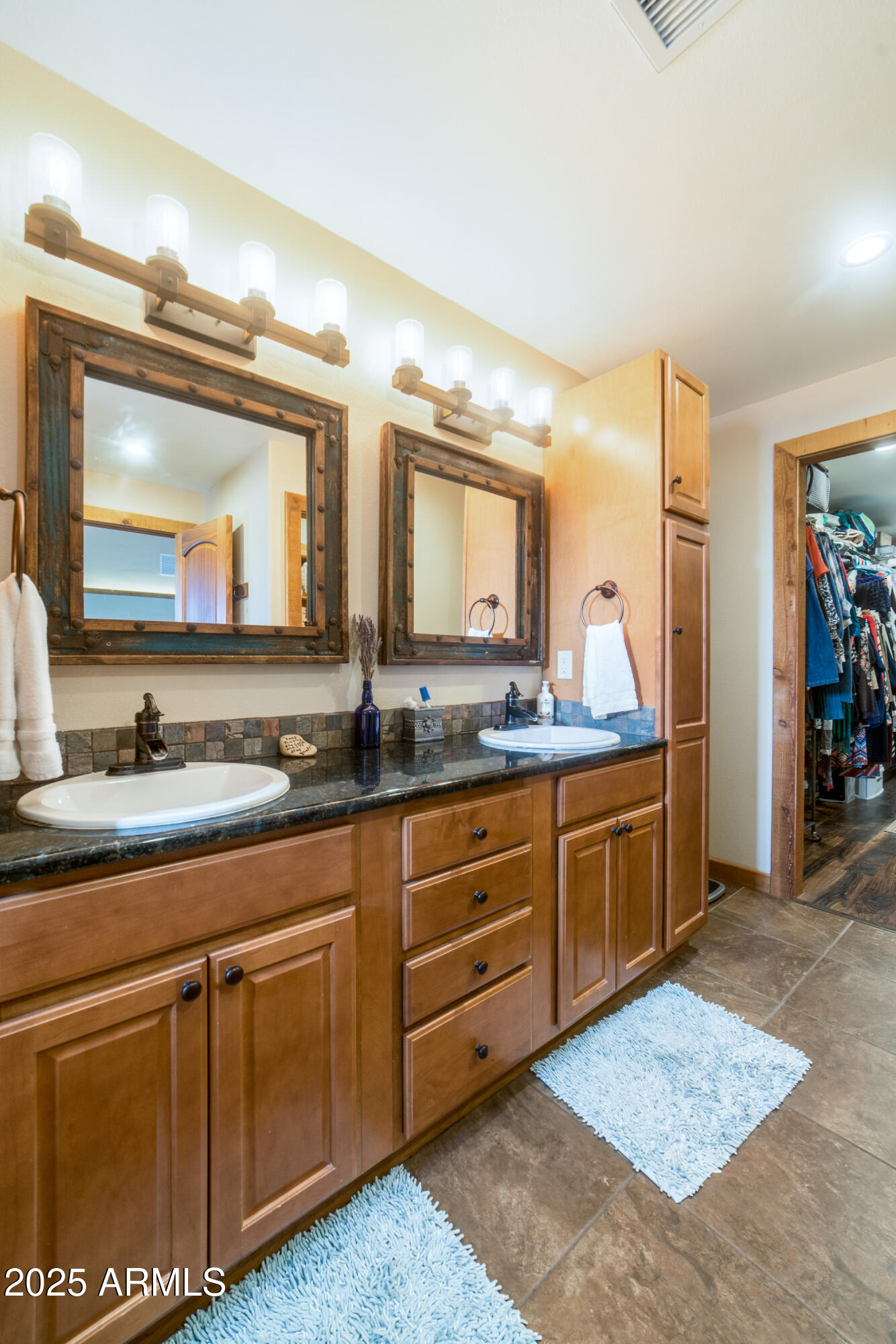 68 Curly Horse Ranch Road Sonoita, AZ 85637 - Photo 18 of 39 a spacious bathroom with a granite countertop sink and a mirror