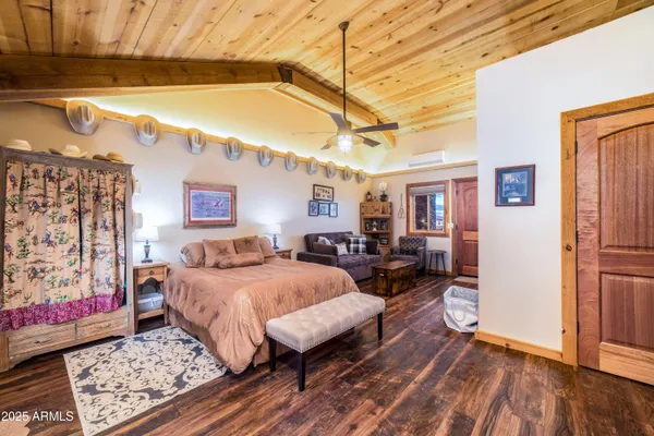 a bedroom with furniture and a large mirror