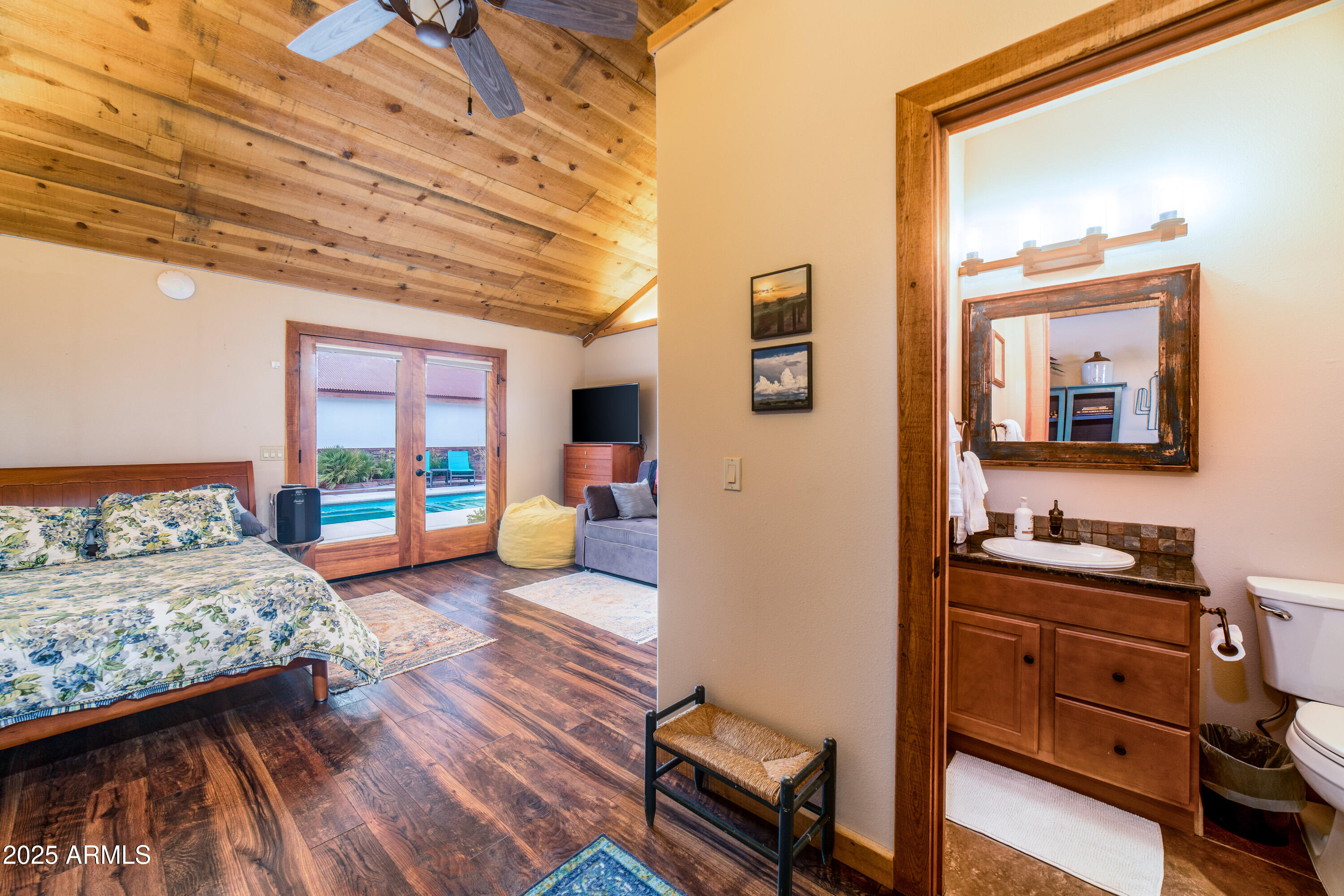 68 Curly Horse Ranch Road Sonoita, AZ 85637 - Photo 24 of 39 a bedroom with furniture and a large mirror