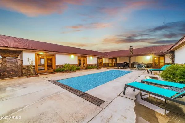 a view of a backyard with sitting area