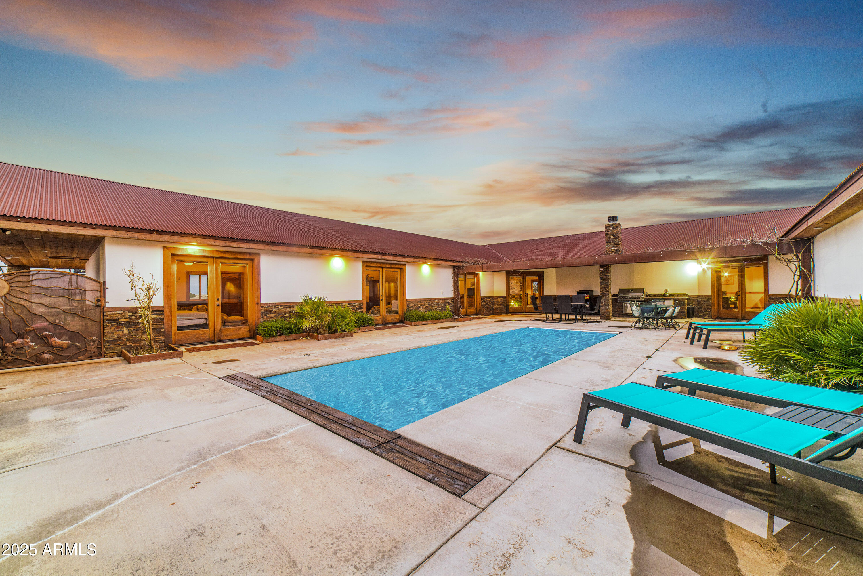68 Curly Horse Ranch Road Sonoita, AZ 85637 - Photo 25 of 39 a swimming pool with outdoor seating and yard