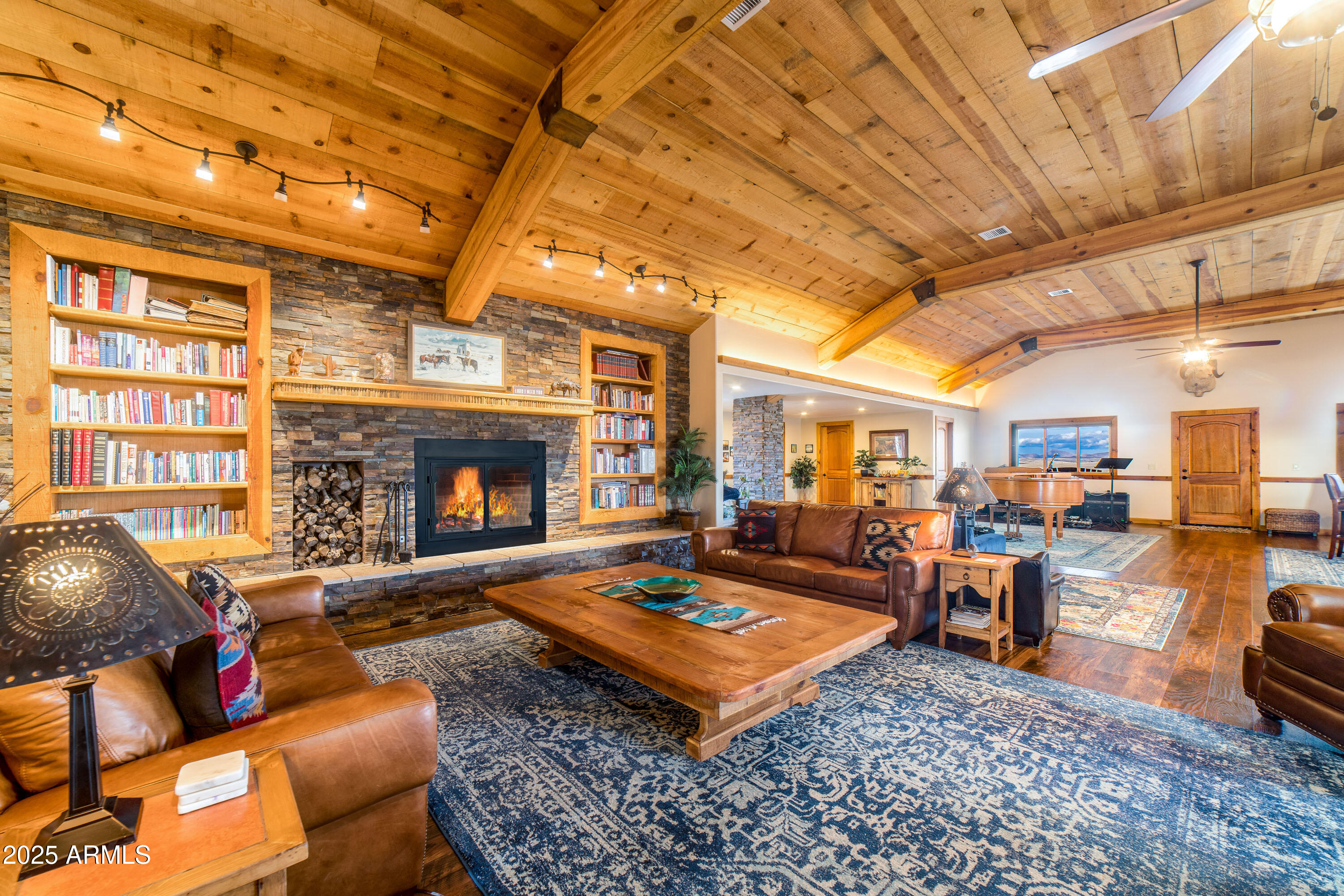 68 Curly Horse Ranch Road Sonoita, AZ 85637 - Photo 3 of 39 a living room with furniture a dining table and a fireplace