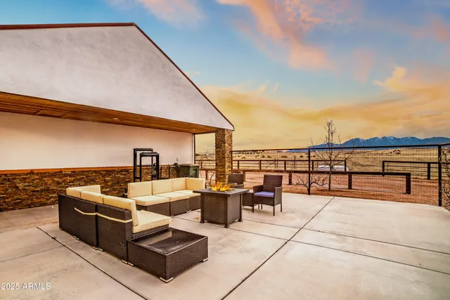 a balcony with furniture and a rug