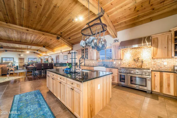 a kitchen with stainless steel appliances granite countertop a sink and cabinets