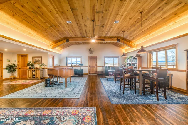 a dining room with furniture and a book shelf