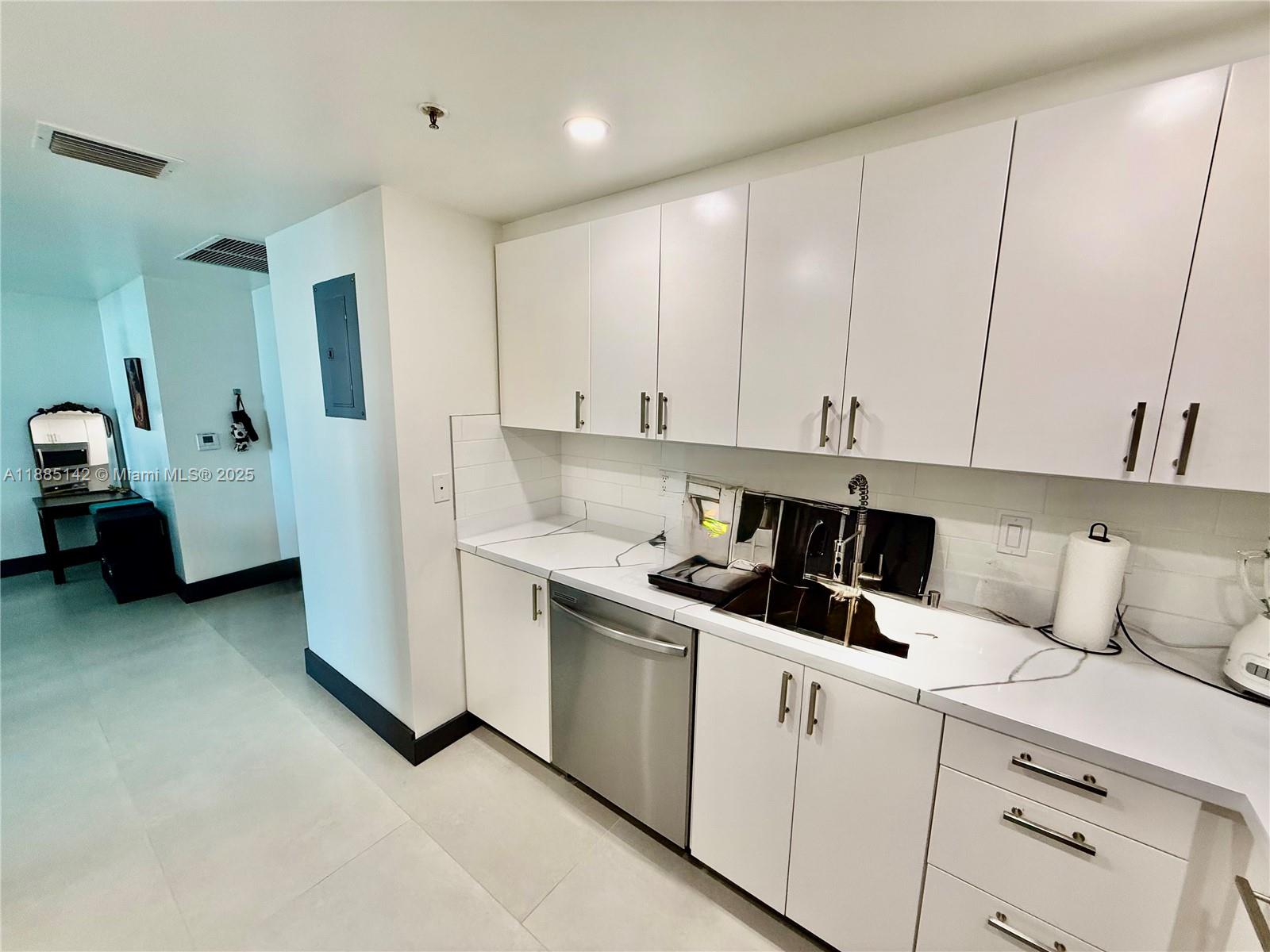 1250 South Miami Avenue, Unit 1603 Miami, FL 33130 - Photo 17 of 44 a kitchen with a cabinets and white appliances