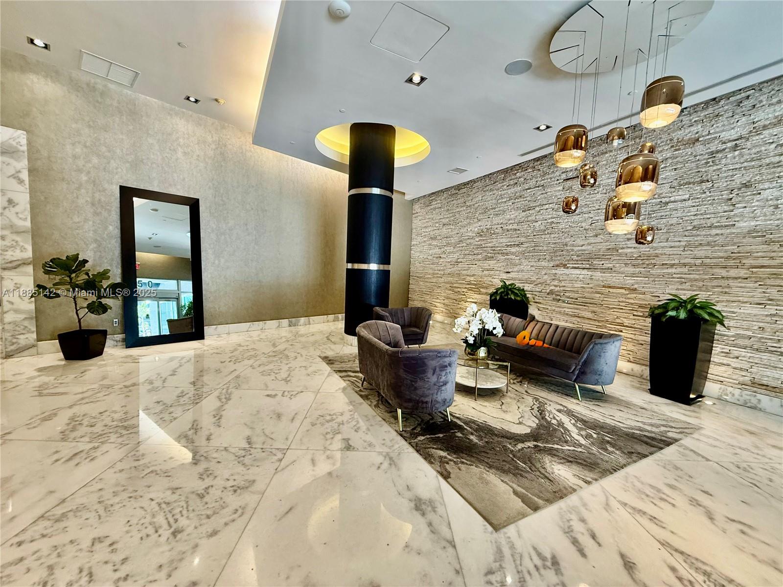 1250 South Miami Avenue, Unit 1603 Miami, FL 33130 - Photo 2 of 44 a bedroom with bed and a chandelier