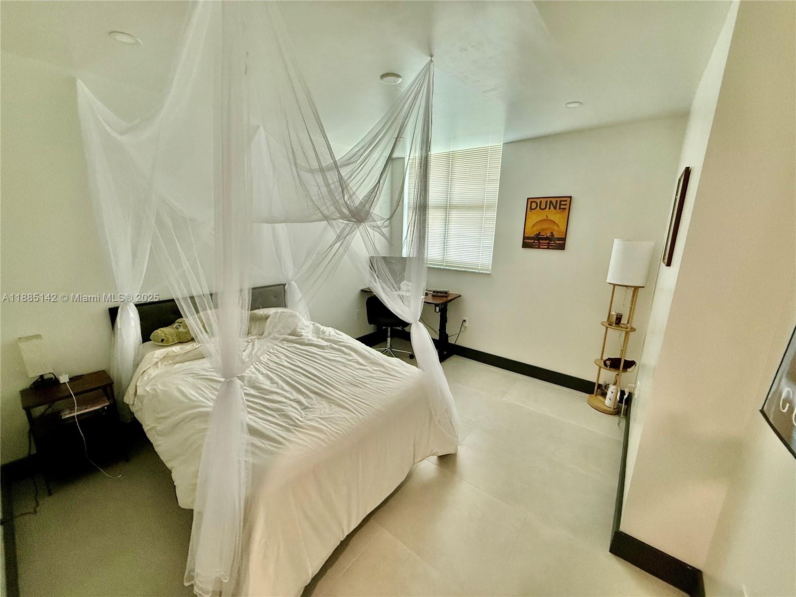 1250 South Miami Avenue, Unit 1603 Miami, FL 33130 - Photo 26 of 44 a bedroom with a bed and a night stand