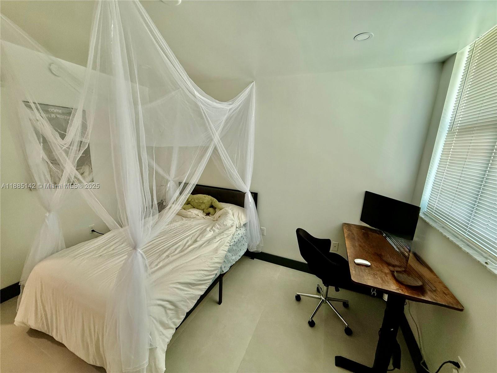 1250 South Miami Avenue, Unit 1603 Miami, FL 33130 - Photo 27 of 44 a bedroom with a bed and a window