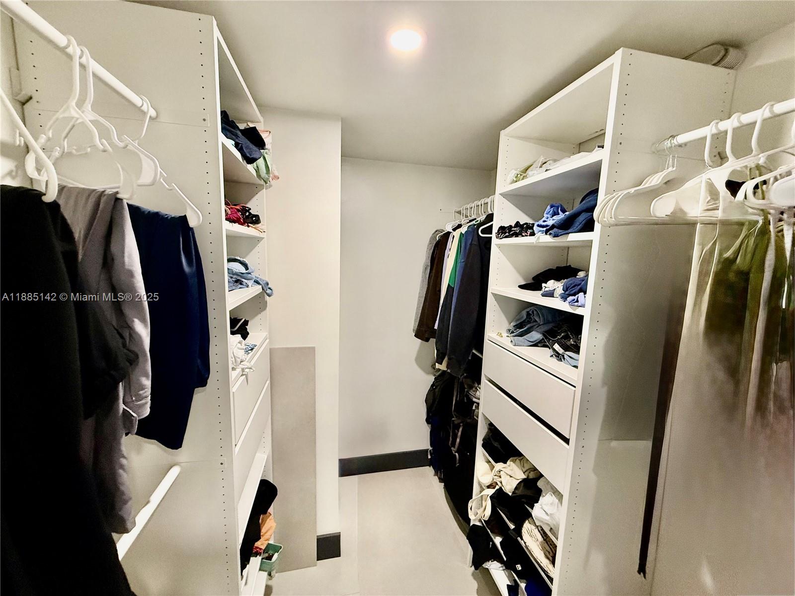 1250 South Miami Avenue, Unit 1603 Miami, FL 33130 - Photo 28 of 44 a view of walk in closet with clothes and shoes