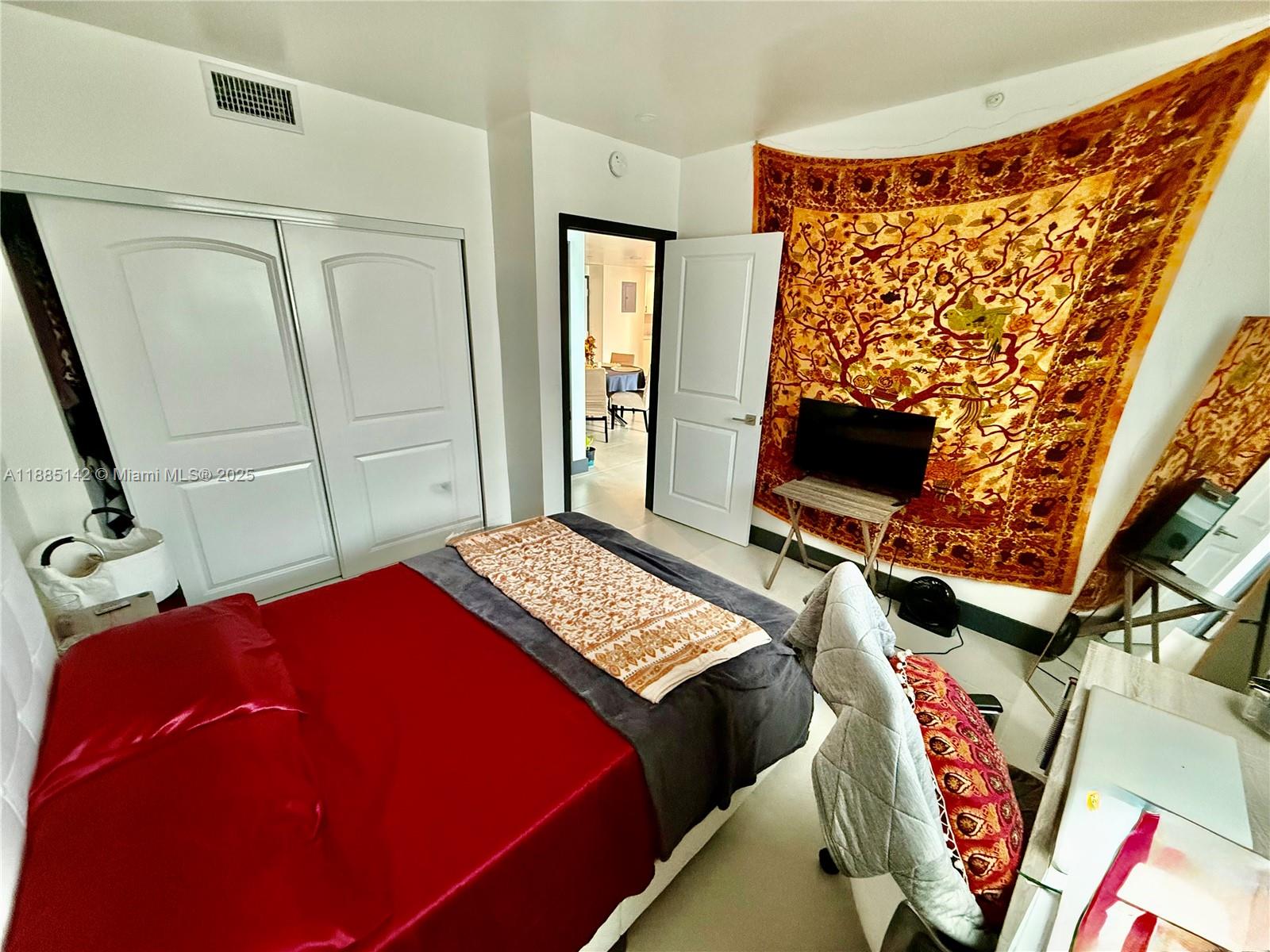 1250 South Miami Avenue, Unit 1603 Miami, FL 33130 - Photo 31 of 44 a bedroom with a bed and a flat screen tv