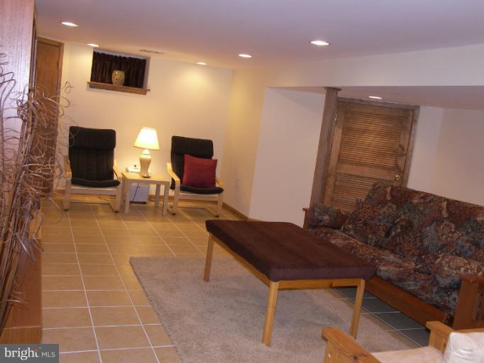 1204 Oakland Terrace Road Halethorpe, MD 21227 - Photo 1 of 4 a living room with furniture and a flat screen tv