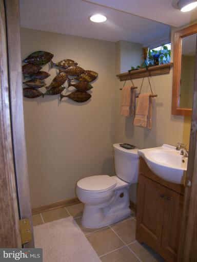 1204 Oakland Terrace Road Halethorpe, MD 21227 - Photo 2 of 4 a bathroom with a toilet a sink and a shower