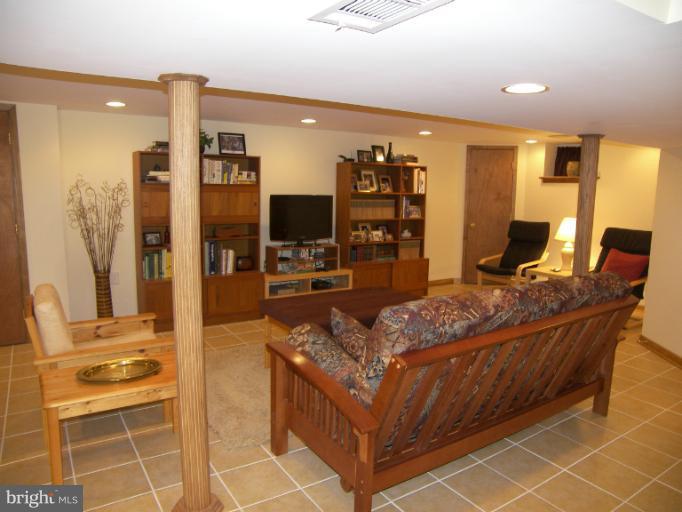 1204 Oakland Terrace Road Halethorpe, MD 21227 - Photo 3 of 4 a living room with furniture a flat screen tv and a dining table