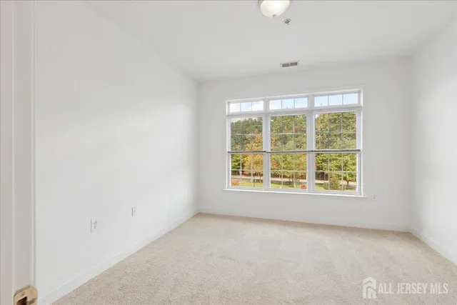 a bathroom with a sink a toilet a mirror and shower